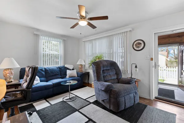 a view of a house with a yard and sitting area