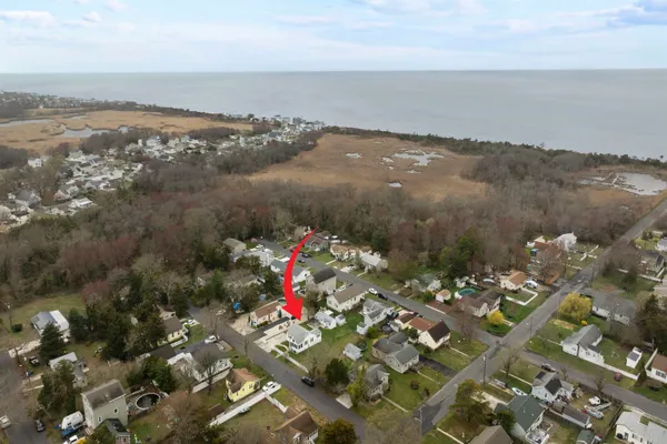 a living room with furniture a flat screen tv and windows