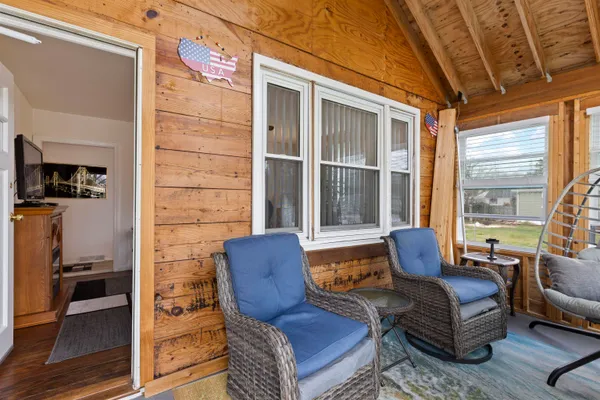 a bedroom with a bed and a flat tv screen on dresser