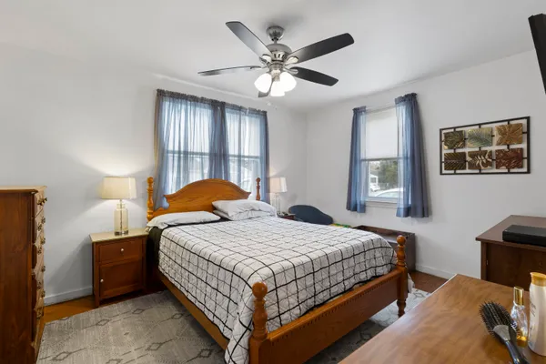 a bedroom with a bed and a flat tv screen on dresser