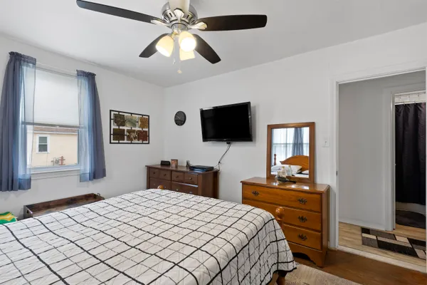 a bedroom with a bed and a flat screen tv
