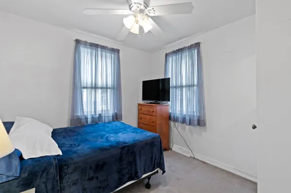 a living room with furniture a flat screen tv and kitchen view