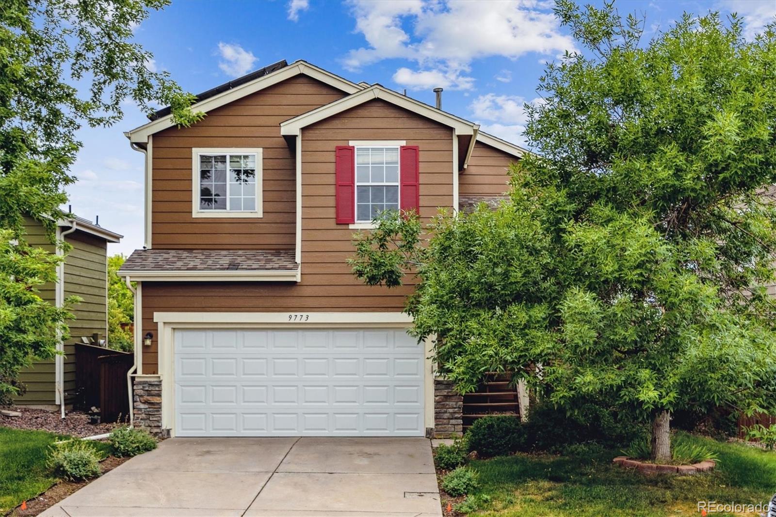 9773 Saybrook Street Highlands Ranch, CO 80126 - Photo 1 of 21 a view of a house with a yard and large tree