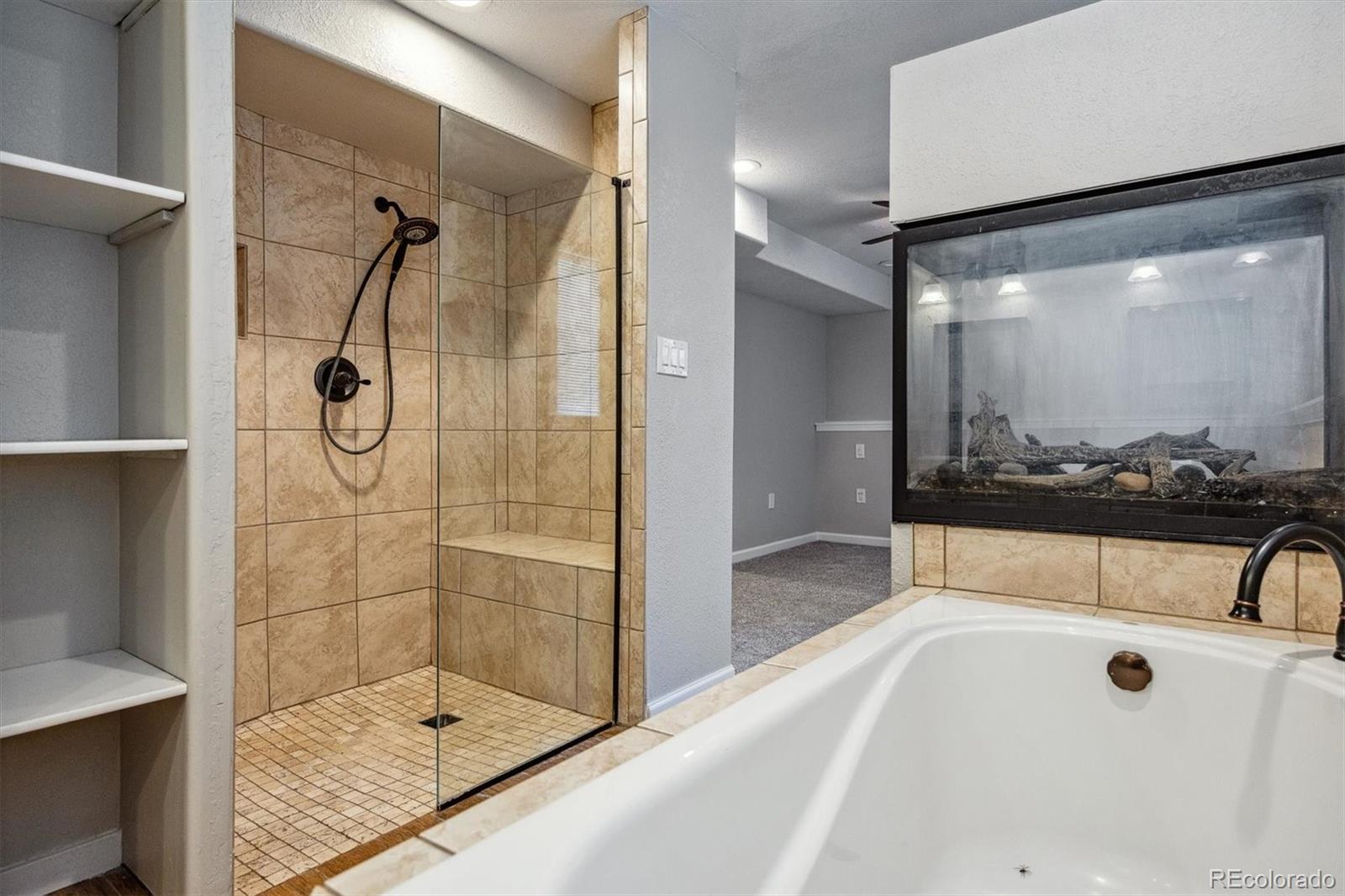 9773 Saybrook Street Highlands Ranch, CO 80126 - Photo 11 of 21 a bathroom with a tub and a shower
