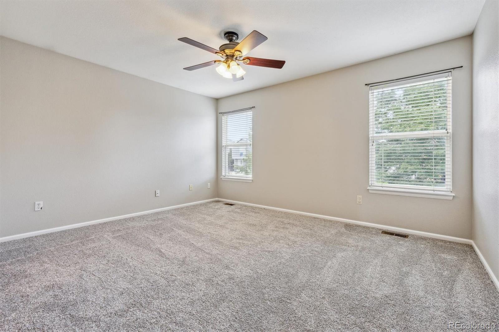 9773 Saybrook Street Highlands Ranch, CO 80126 - Photo 12 of 21 an empty room with windows and fan