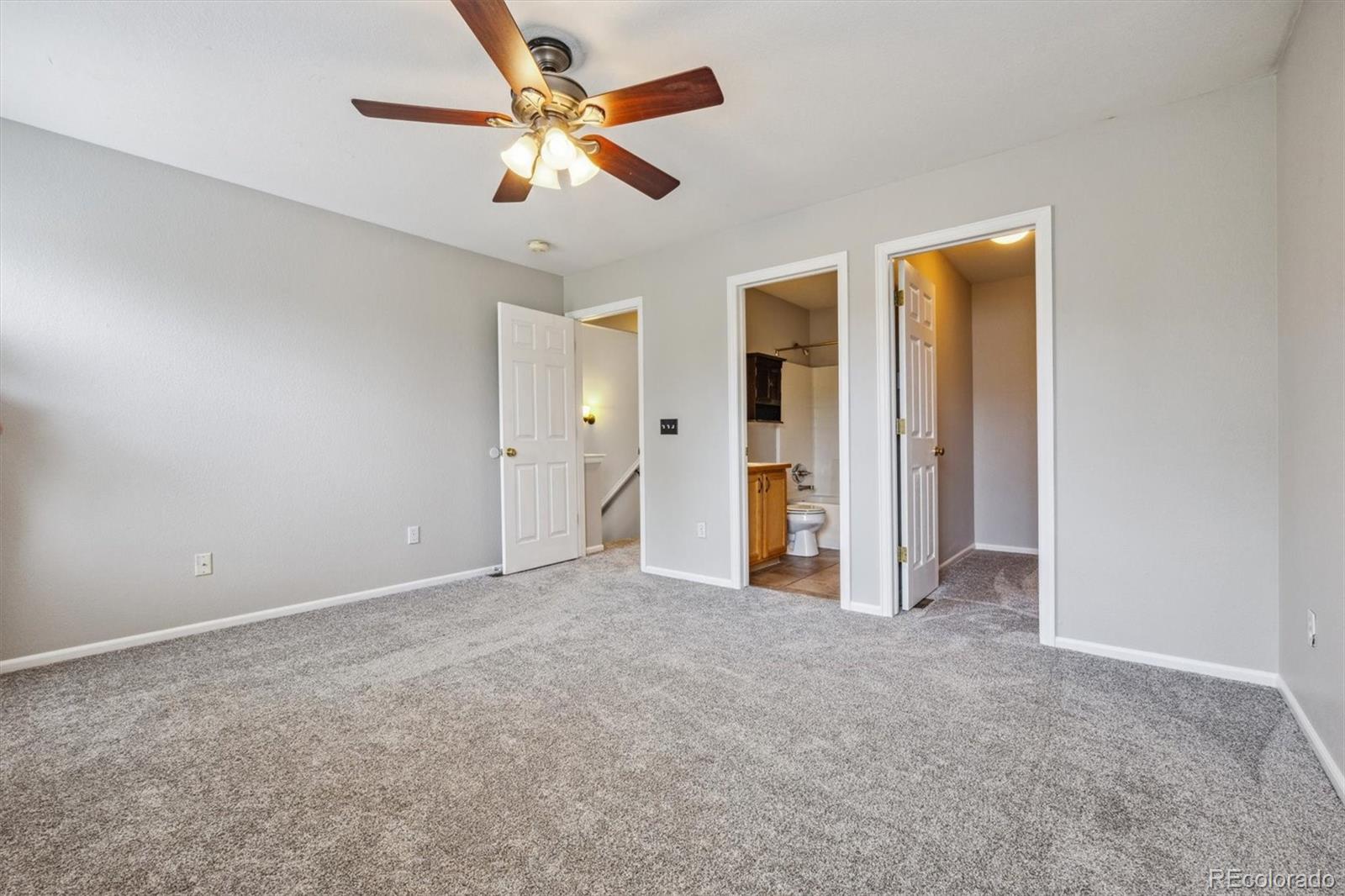 9773 Saybrook Street Highlands Ranch, CO 80126 - Photo 13 of 21 an empty room with closet and a ceiling fan