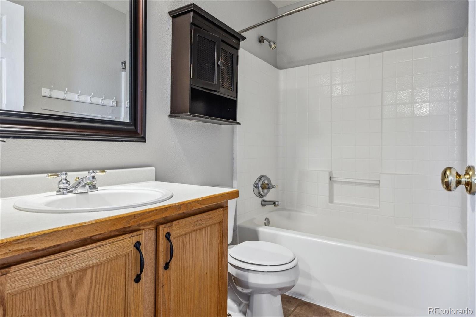 9773 Saybrook Street Highlands Ranch, CO 80126 - Photo 14 of 21 a bathroom with a sink a toilet and shower