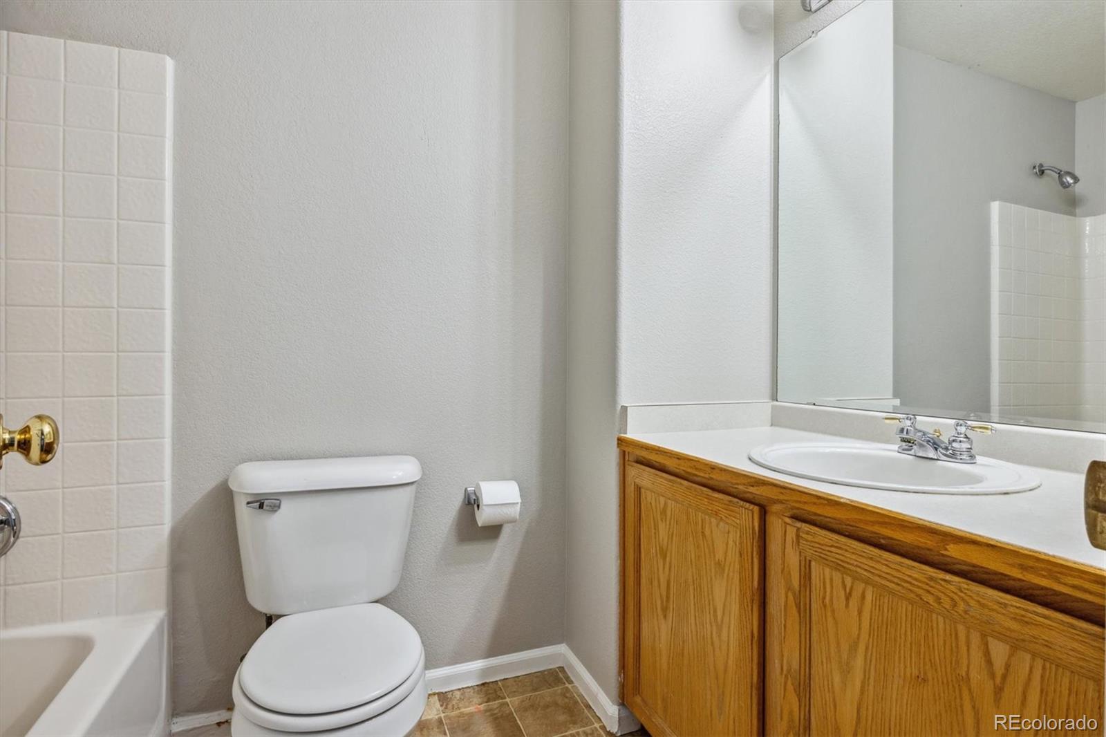 9773 Saybrook Street Highlands Ranch, CO 80126 - Photo 17 of 21 a white toilet sitting next to a bathroom sink