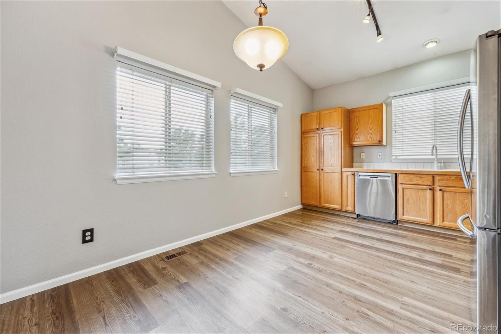 9773 Saybrook Street Highlands Ranch, CO 80126 - Photo 4 of 21 a view of an empty room with a window and wooden floor