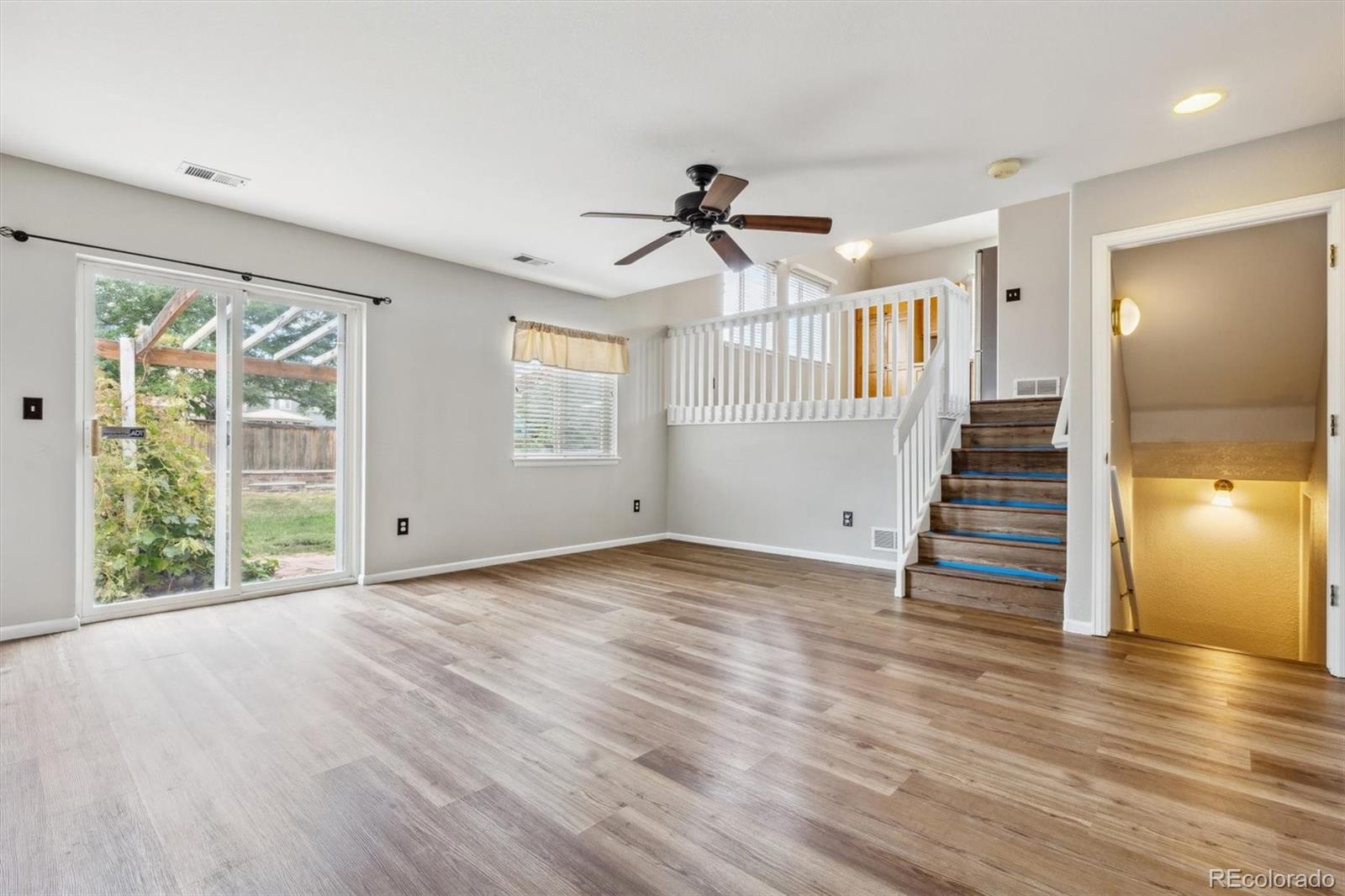 9773 Saybrook Street Highlands Ranch, CO 80126 - Photo 7 of 21 a view of empty room with wooden floor and fan