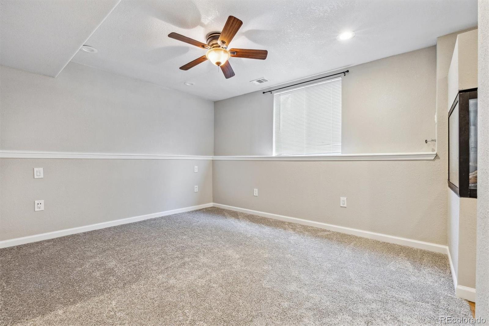 9773 Saybrook Street Highlands Ranch, CO 80126 - Photo 8 of 21 an empty room with closet and windows