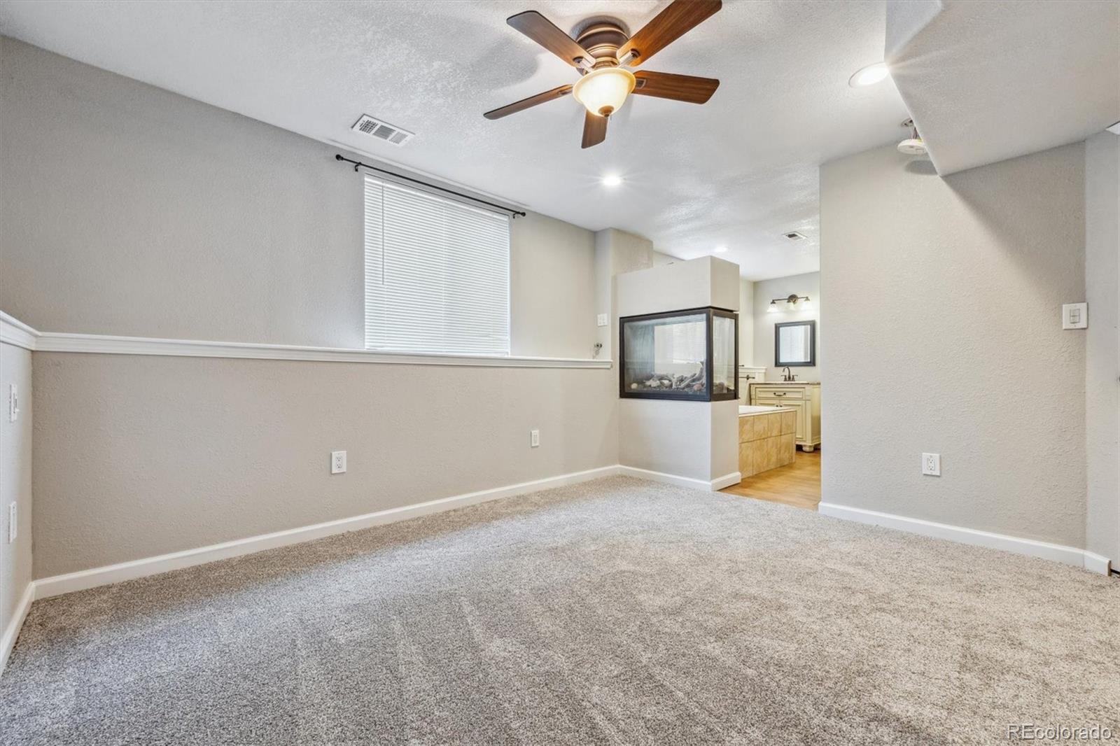 9773 Saybrook Street Highlands Ranch, CO 80126 - Photo 9 of 21 a view of a kitchen with a sink and a refrigerator