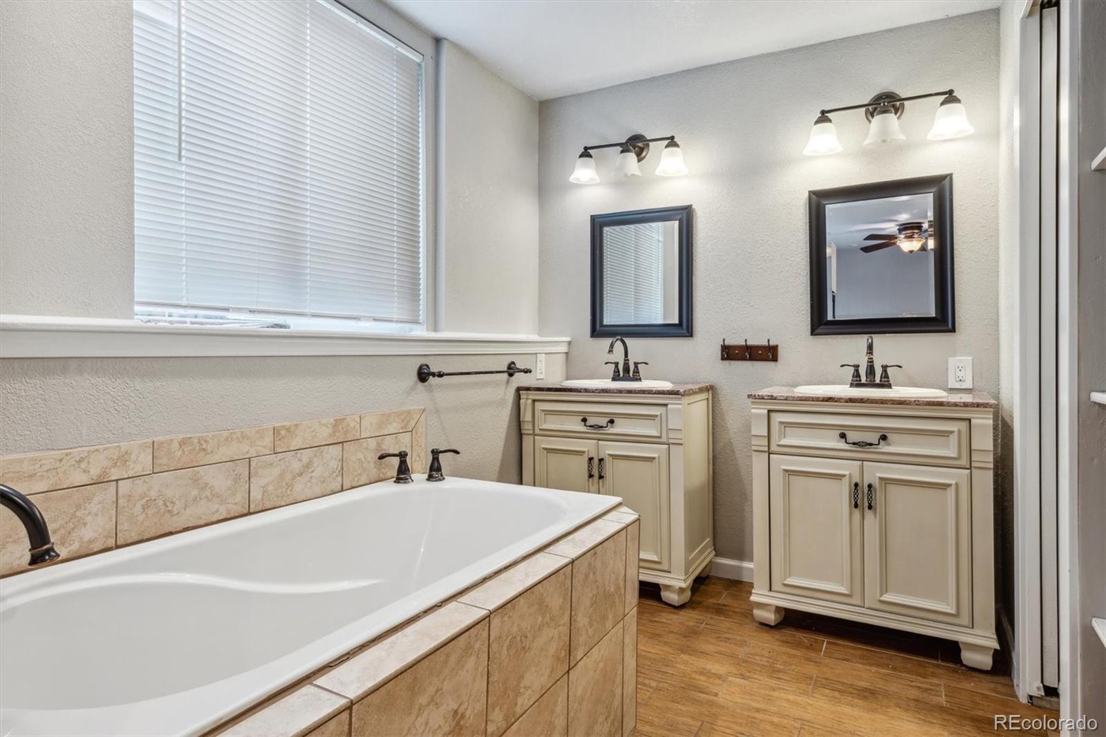9773 Saybrook Street Highlands Ranch, CO 80126 - Photo 10 of 21 a bathroom with a sink and a bathtub