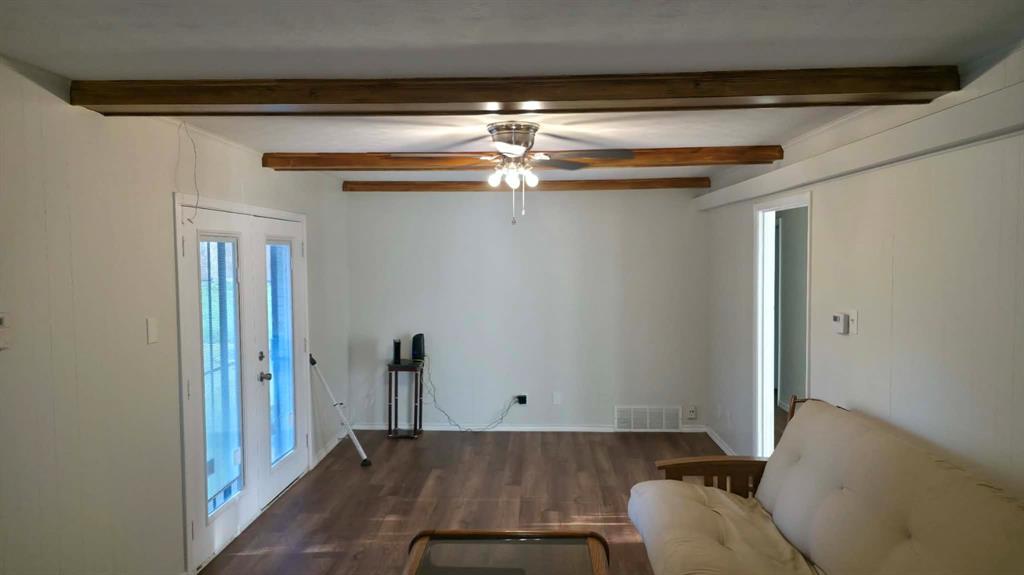 5722 Old Ox Road Dallas, TX 75241 - Photo 5 of 10 a living room with furniture and a chandelier