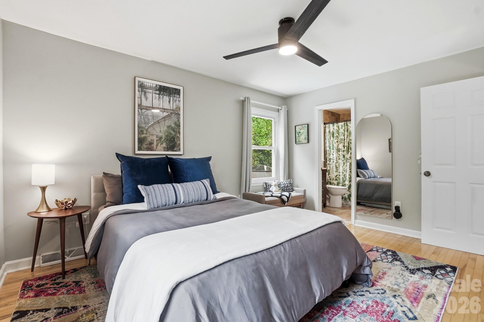 824 Riverwood Road Charlotte, NC 28270 - Photo 11 of 37 a bedroom with a bed and a chandelier