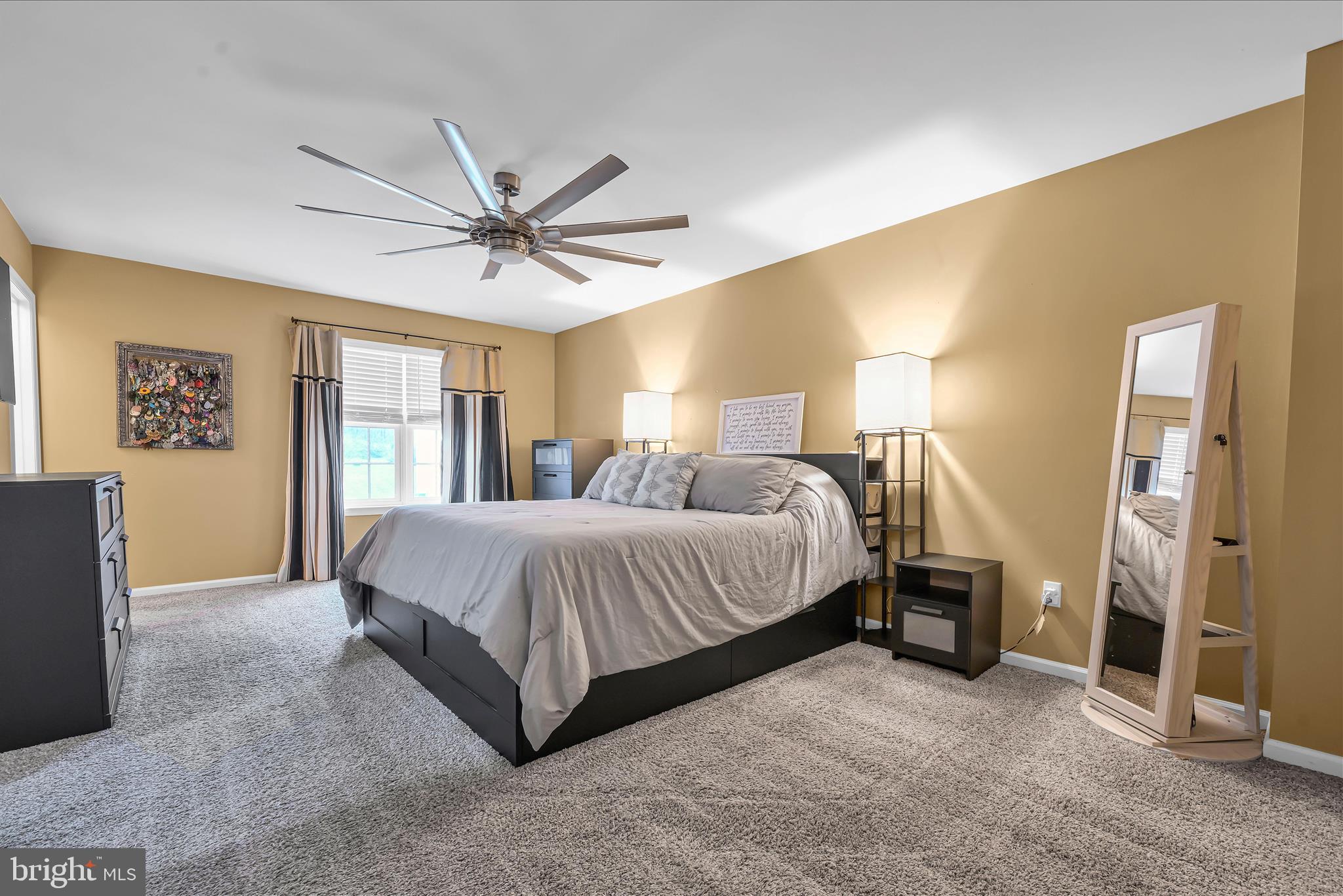 247 Bainbridge Circle Reading, PA 19608 - Photo 11 of 30 a spacious bedroom with a bed and a chandelier