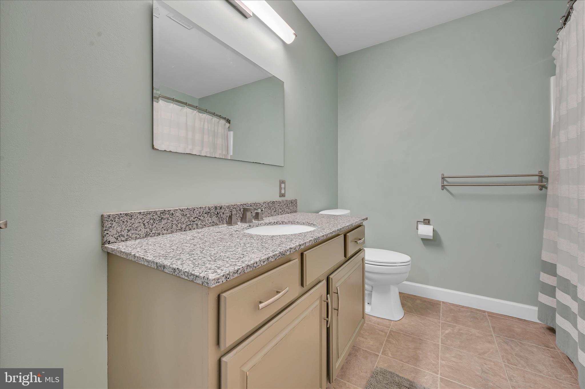 247 Bainbridge Circle Reading, PA 19608 - Photo 17 of 30 a bathroom with a granite countertop sink and a toilet