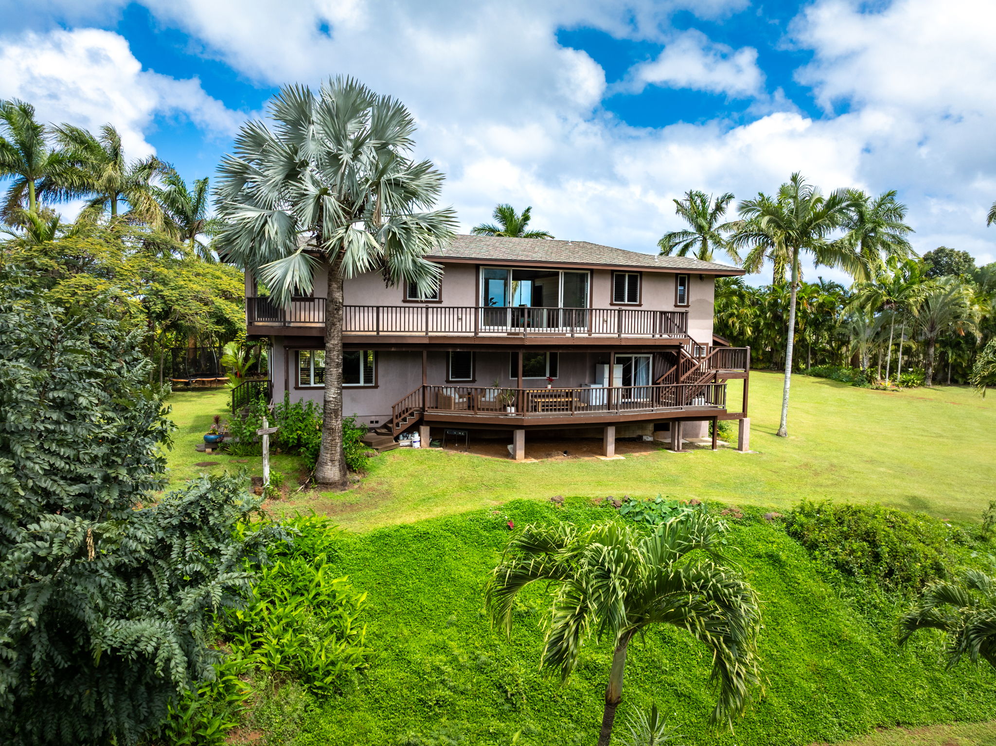 7473 E Koolau Road Kilauea, HI 96754 - Photo 21 of 30 a view of a swimming pool with plants and large trees