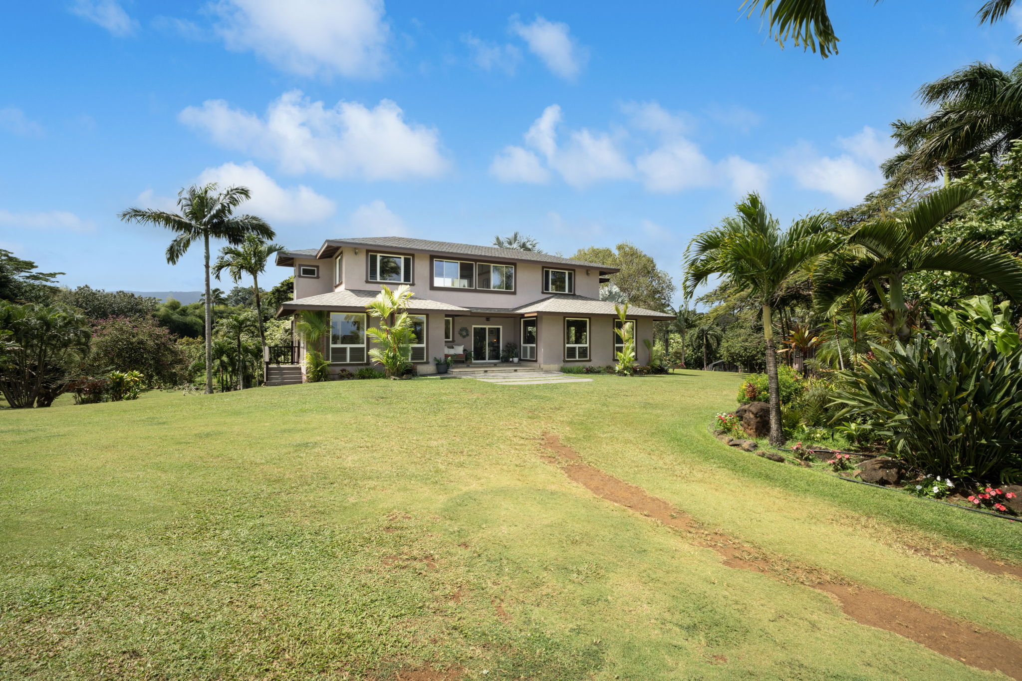 7473 E Koolau Road Kilauea, HI 96754 - Photo 4 of 30 a front view of a house with a garden