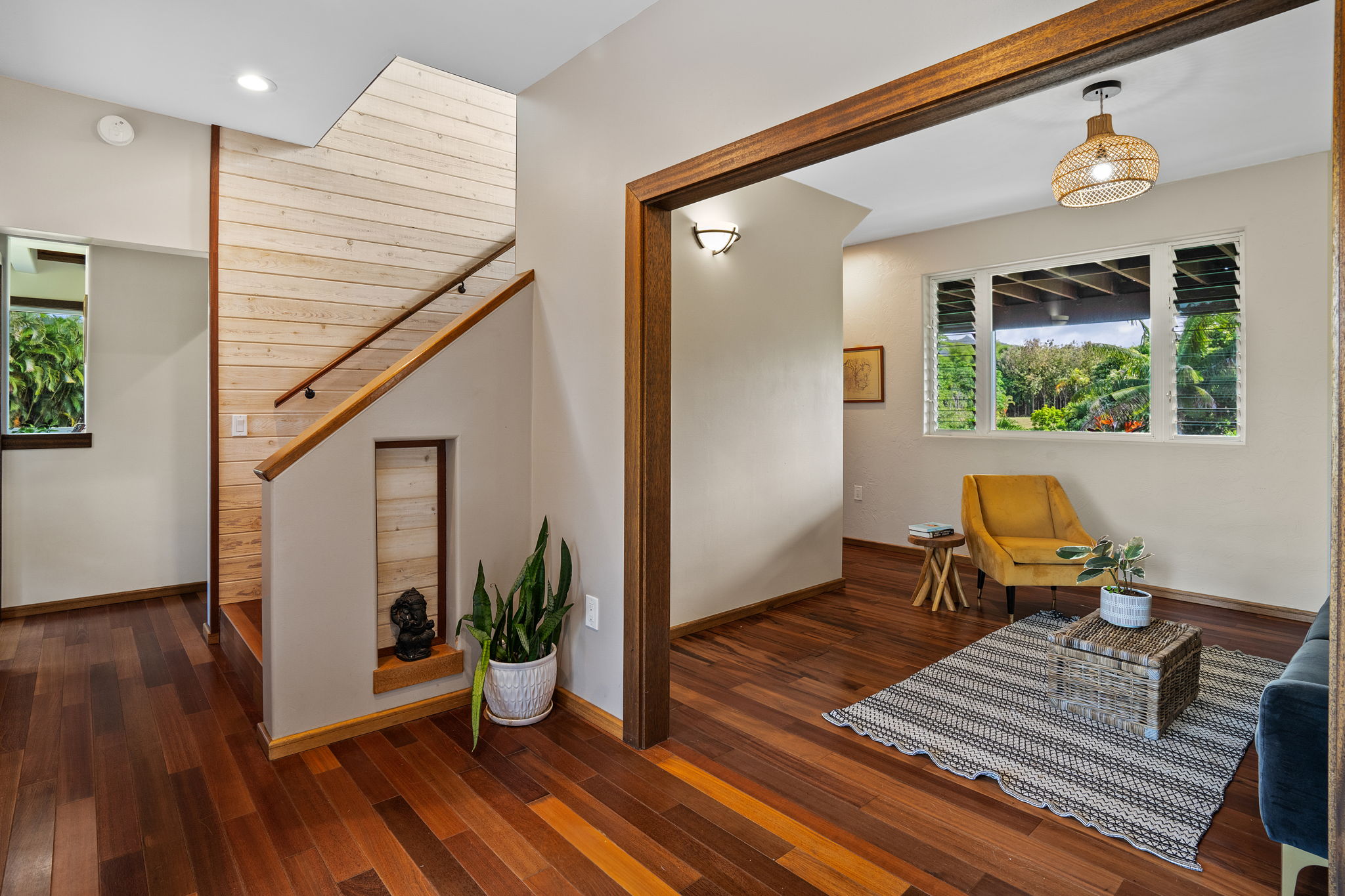 7473 E Koolau Road Kilauea, HI 96754 - Photo 9 of 30 a view of a hallway with wooden floor and glass door