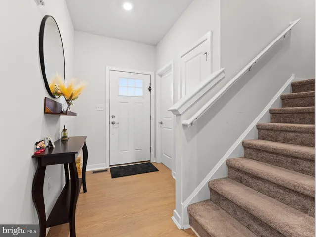 a kitchen with stainless steel appliances granite countertop a sink a stove a refrigerator a microwave oven with cabinets and wooden floor