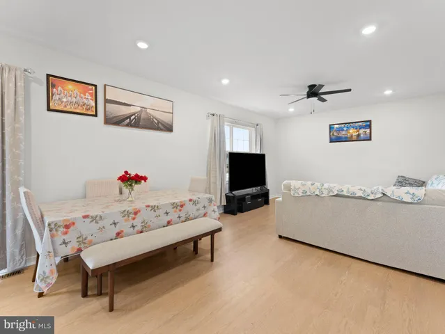 a spacious bedroom with a bed and a dresser