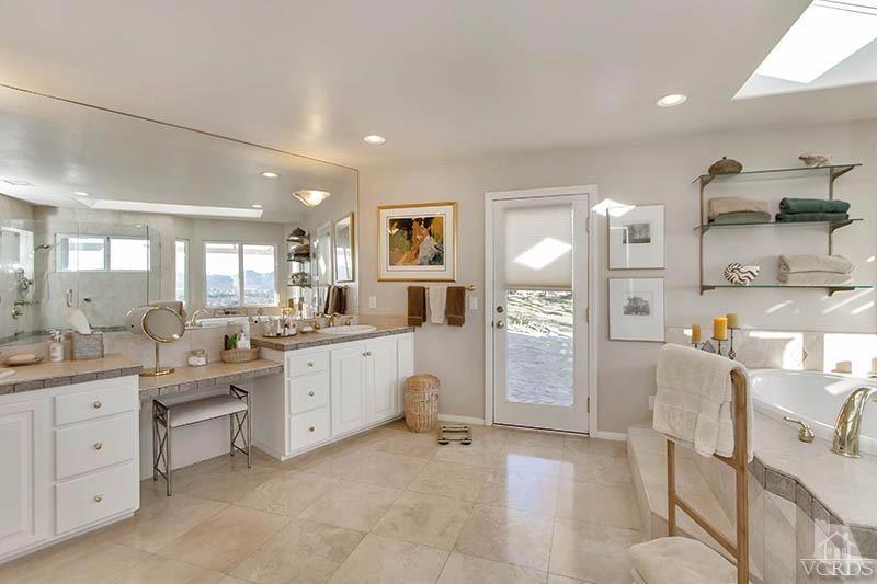 520 San Clemente Way Camarillo, CA 93010 - Photo 21 of 49 a large kitchen with white cabinets and wooden floors