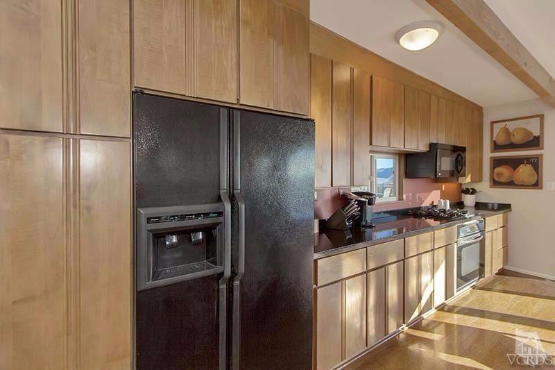520 San Clemente Way Camarillo, CA 93010 - Photo 9 of 49 a kitchen with stainless steel appliances granite countertop a refrigerator a stove and a sink with wooden floor