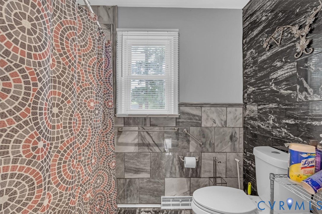 406 Windmere Drive Colonial Heights, VA 23834 - Photo 11 of 29 a bathroom with a toilet and a shower curtain