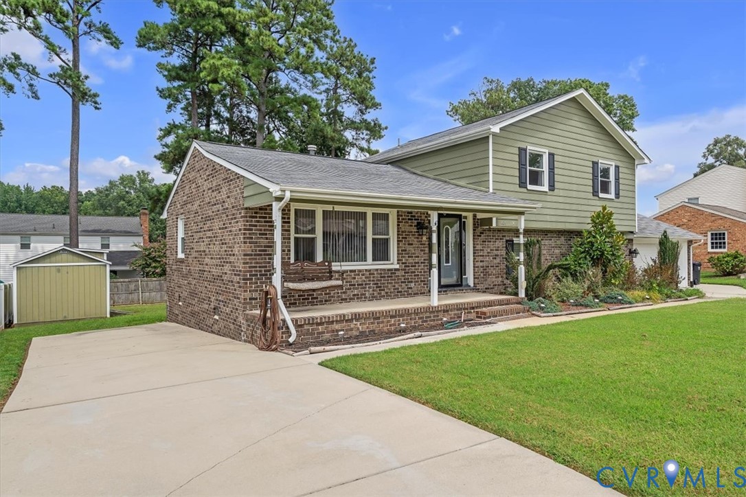 406 Windmere Drive Colonial Heights, VA 23834 - Photo 28 of 29 a front view of a house with a garden and yard