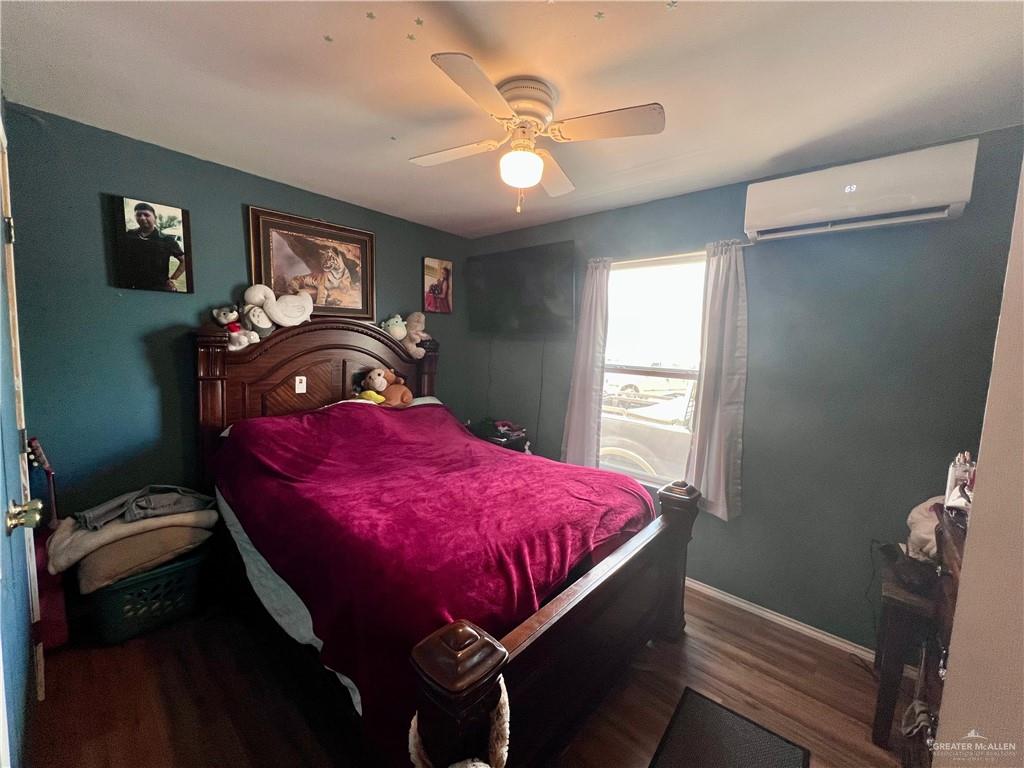 38416 El Quelite Road Penitas, TX 78576 - Photo 14 of 20 a bed room with a bed window and a chandelier