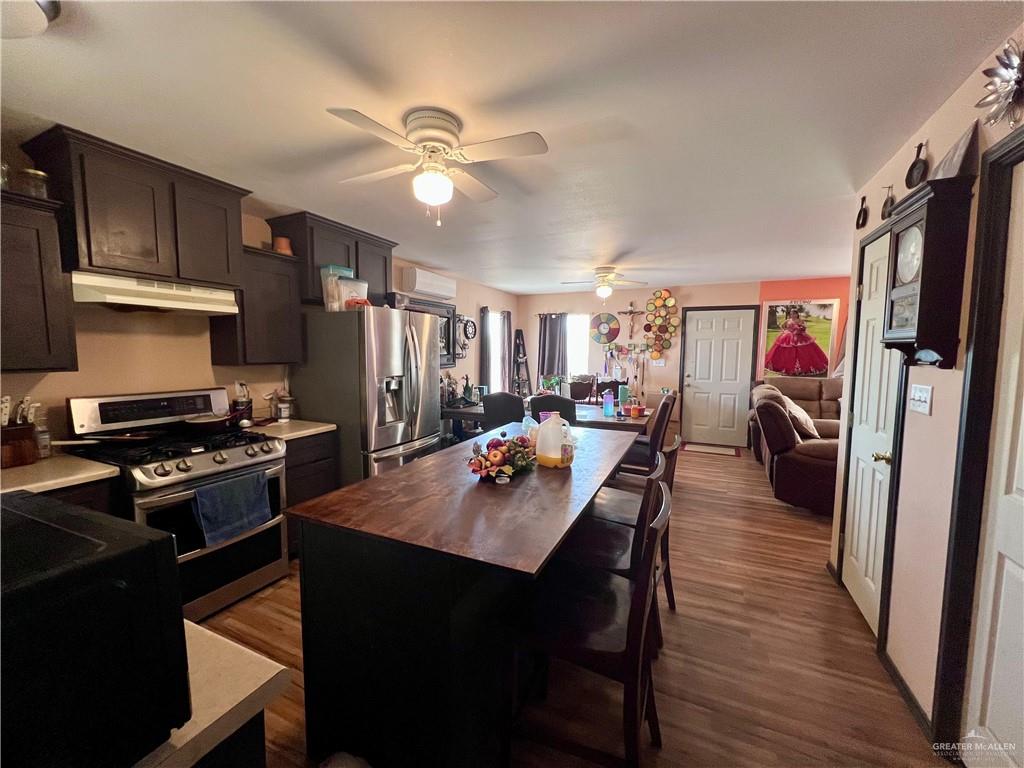 38416 El Quelite Road Penitas, TX 78576 - Photo 5 of 20 a dining room with wooden floor and stainless steel appliances
