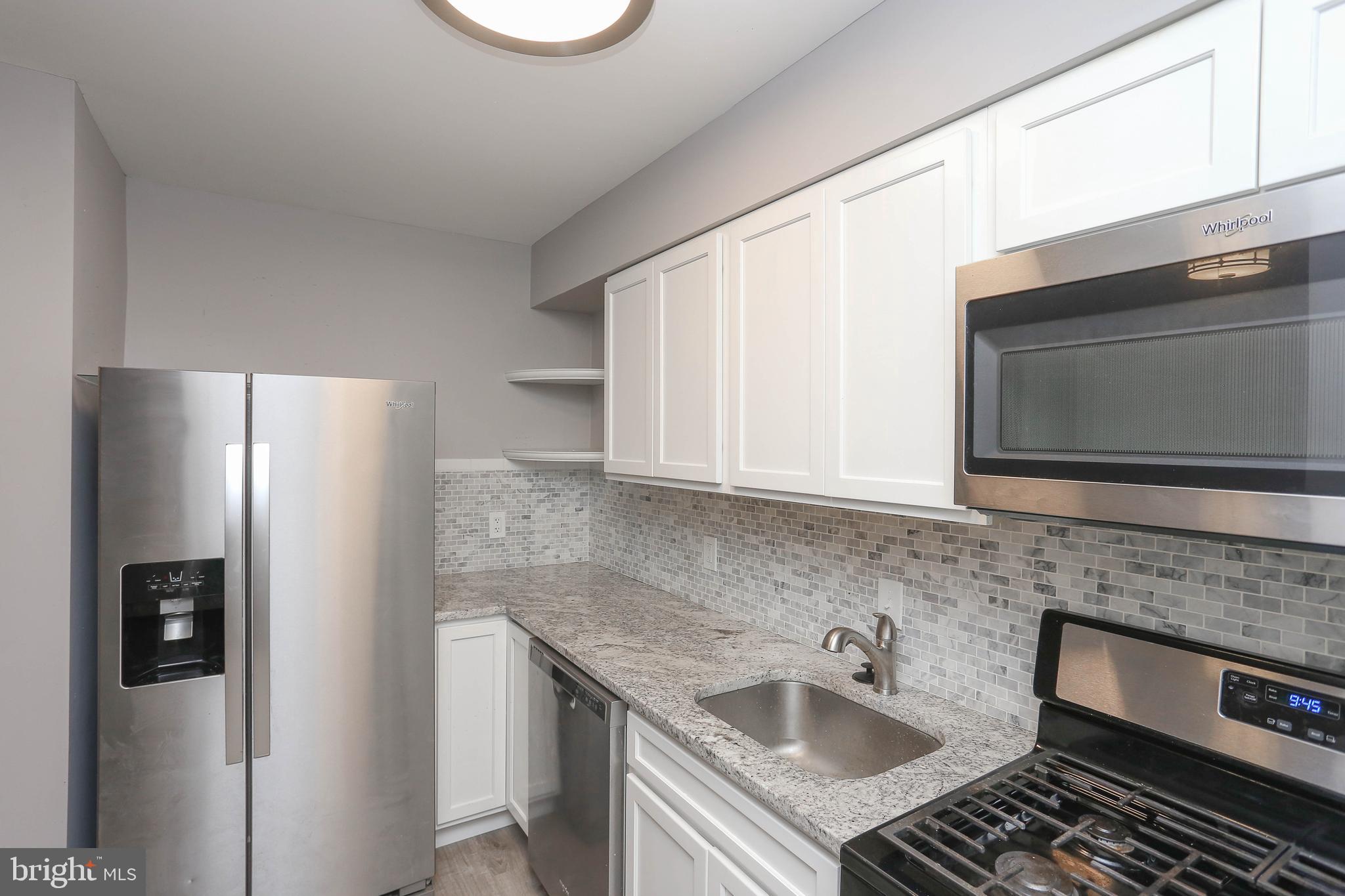 1932 Inverton Road Baltimore, MD 21222 - Photo 15 of 30 a kitchen with stainless steel appliances granite countertop a sink stove and refrigerator