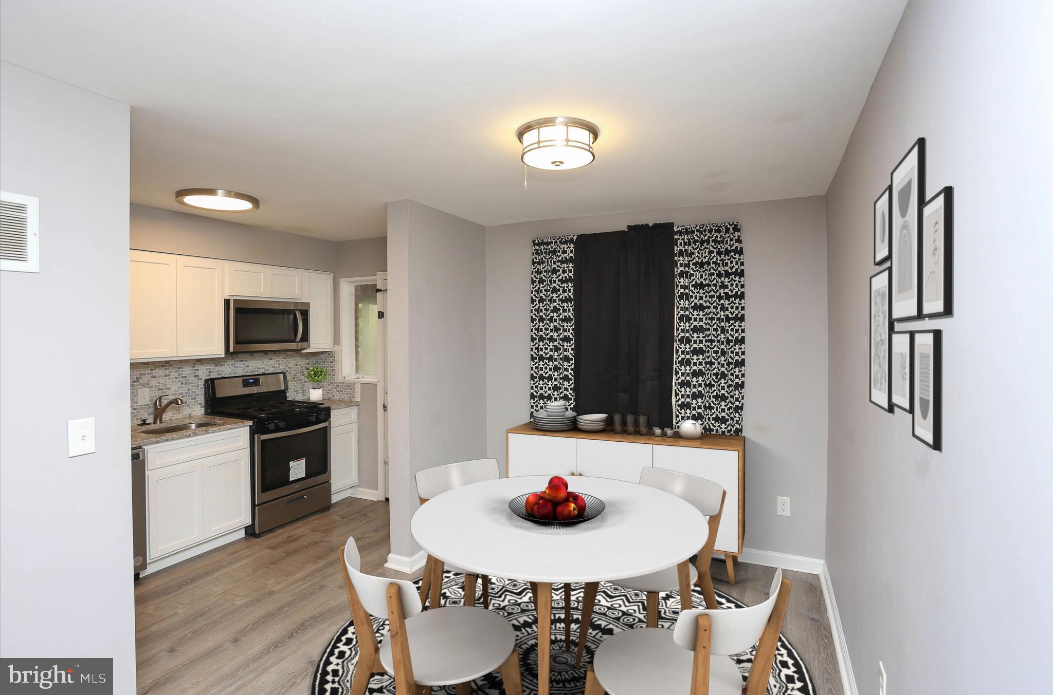 1932 Inverton Road Baltimore, MD 21222 - Photo 16 of 30 a kitchen with stainless steel appliances a dining table and chairs