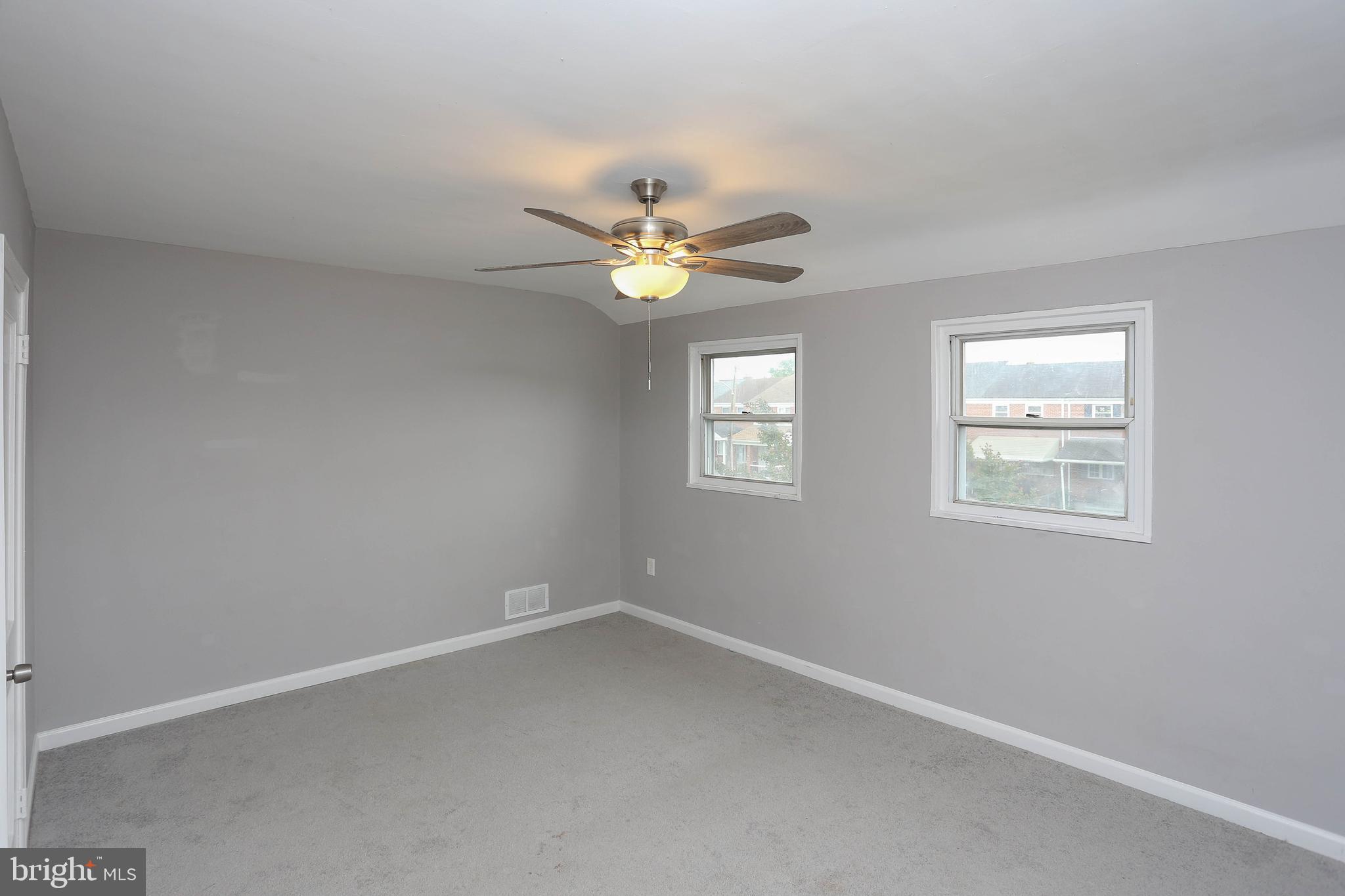 1932 Inverton Road Baltimore, MD 21222 - Photo 19 of 30 an empty room with windows and chandelier fan