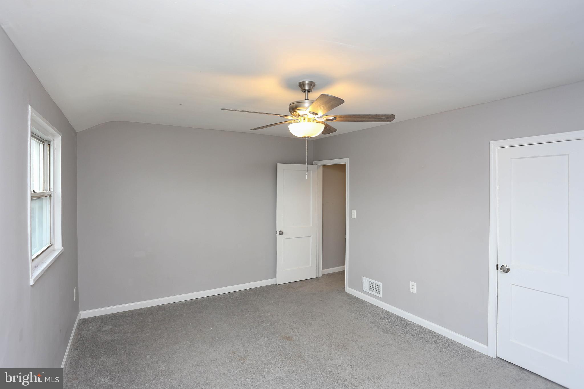 1932 Inverton Road Baltimore, MD 21222 - Photo 20 of 30 a view of an empty room with a chandelier fan