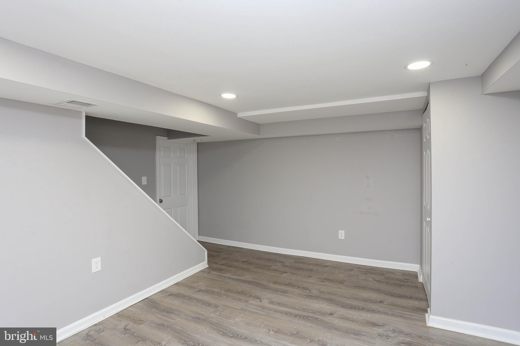 1932 Inverton Road Baltimore, MD 21222 - Photo 27 of 30 a view of an empty room with wooden floor