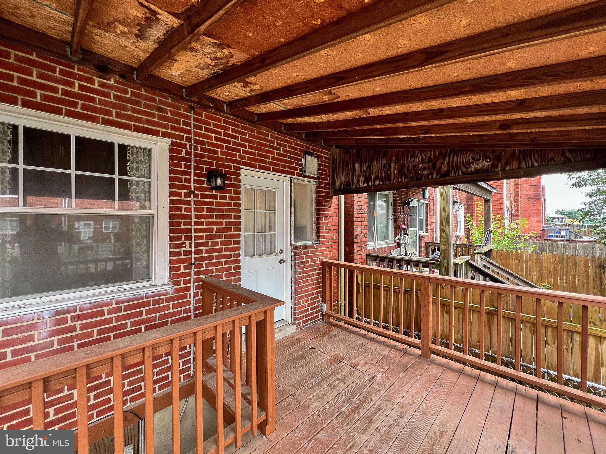 1932 Inverton Road Baltimore, MD 21222 - Photo 6 of 30 a view of an empty room with wooden floor and windows