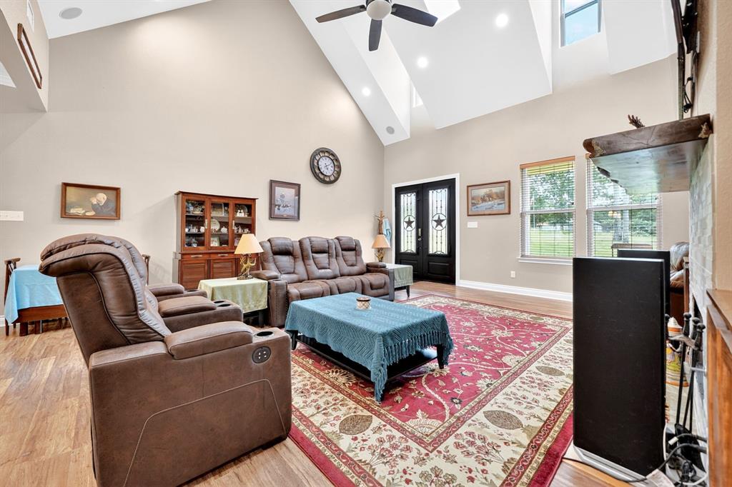 5230 Esquire Estates Road Mabank, TX 75156 - Photo 5 of 39 Spacious living area featuring vaulted ceilings with recessed lighting, a ceiling fan, and skylights