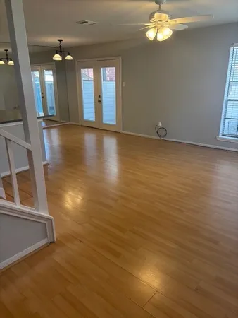 wooden floor in an empty room with a window