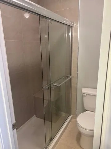 a bathroom with a toilet and a shower
