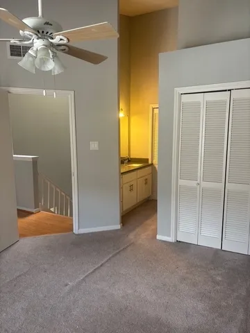 a view of an empty room with closet area