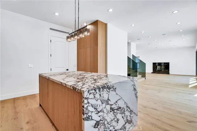 a open kitchen with kitchen island a sink stainless steel appliances and cabinets