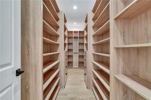 a view of walk in closet with empty racks