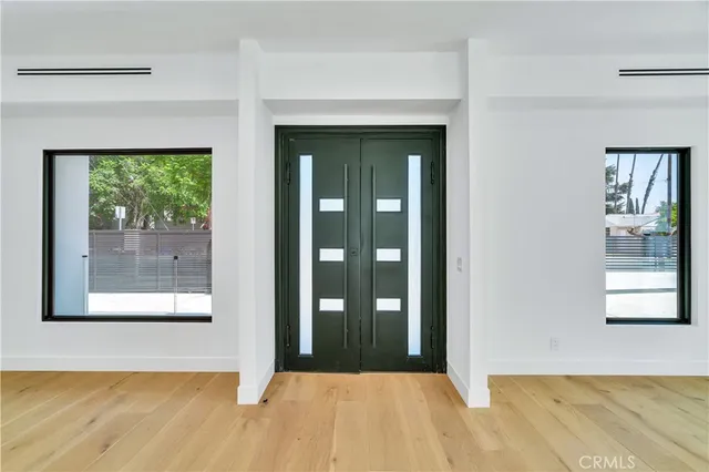 a view of a hallway with wooden floor and a fireplace