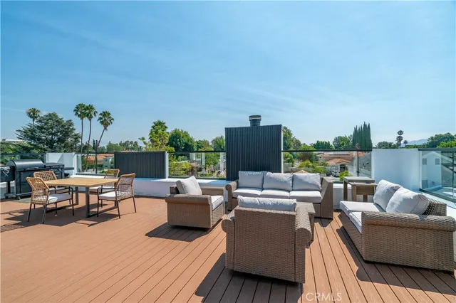 a view of a patio with couches and potted plants