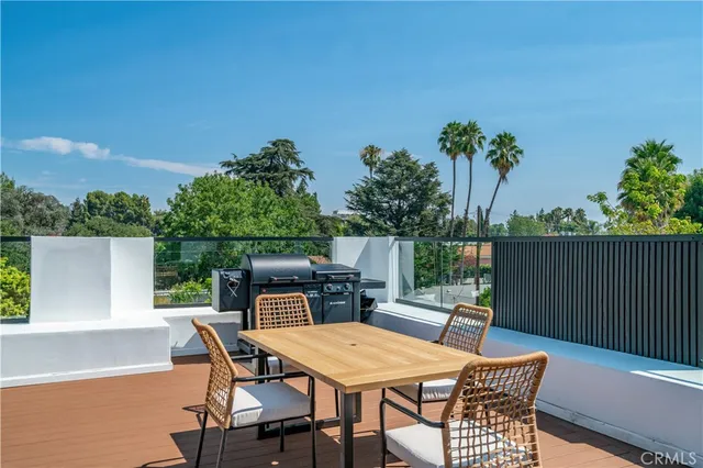 a view of balcony with wooden floor and outdoor seating