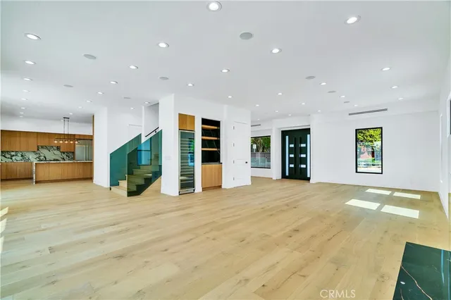 a view of an empty room with closet and a large window