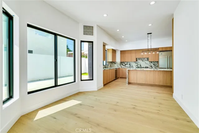 a view of a kitchen with a sink and a large window
