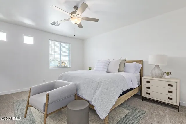 a bedroom with bed and window